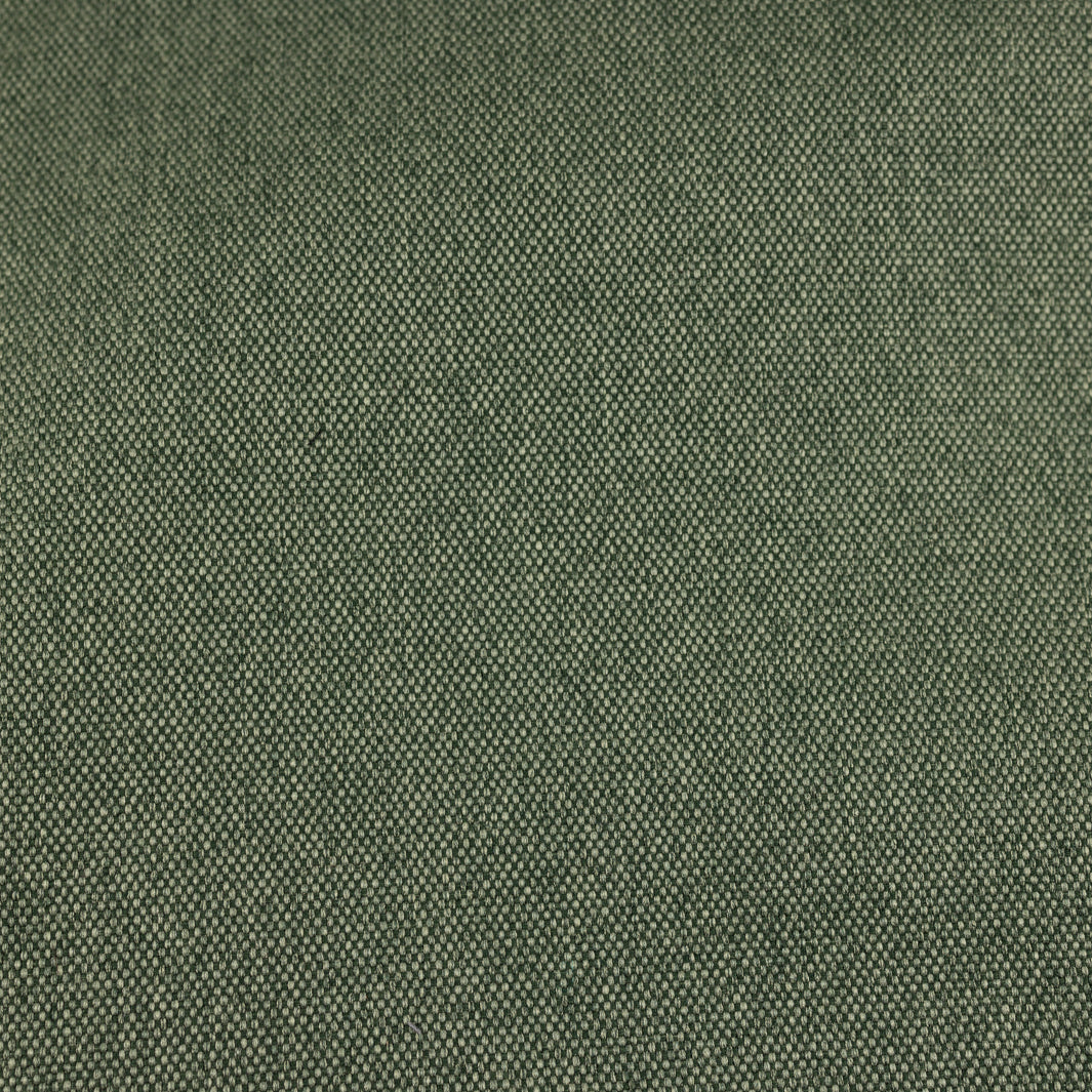 Nahaufnahme des melierten Canvas in Waldgrün, das elegant mit schwarzem Kork kombiniert wird, mit goldenen Messingdetails