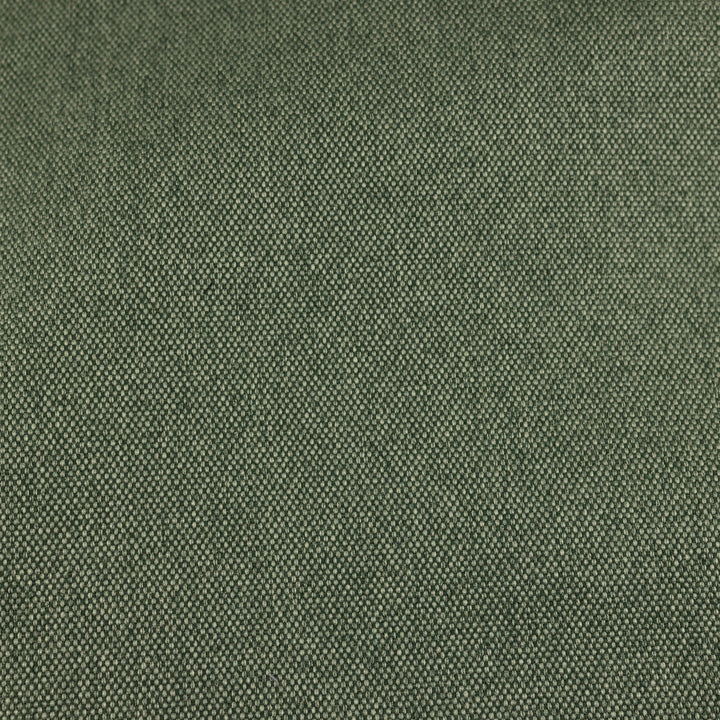 Nahaufnahme des melierten Canvas in Waldgrün, das elegant mit schwarzem Kork kombiniert wird, mit goldenen Messingdetails